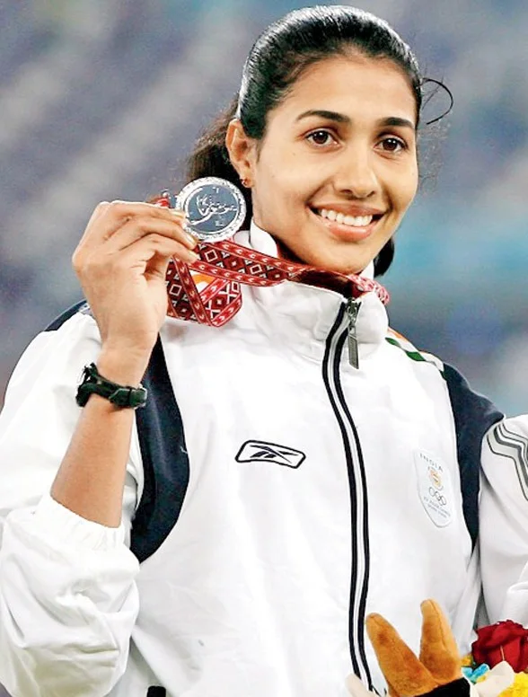 Olympian Anju Bobby George holding her medal